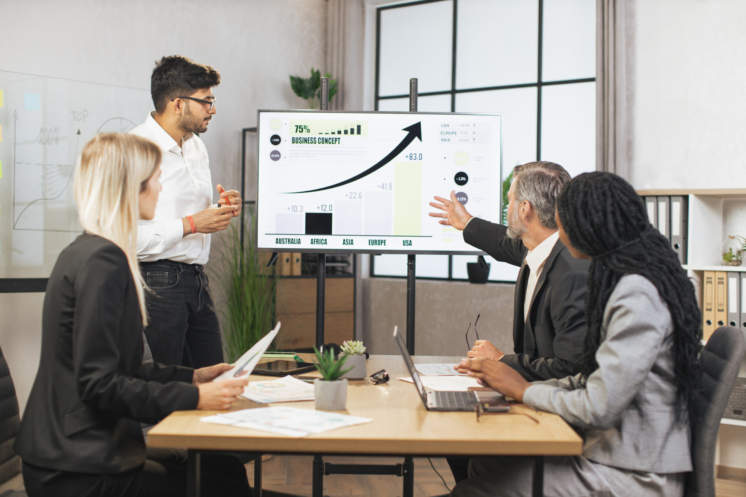 Successful confident experienced diverse team of corporative workers, listening indian male expert,
